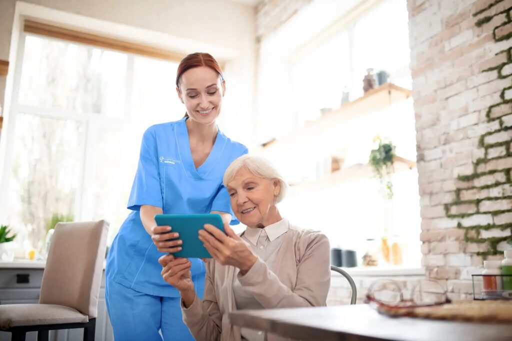 caregiver helping mobile device Home - LightSpring Home Care